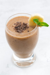 banana chocolate smoothie in a glass, top view