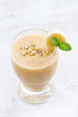 banana smoothie in a glass, top view