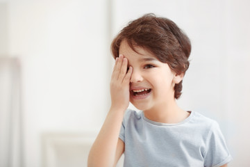 Fototapeta premium Cute emotional little boy on light blurred background