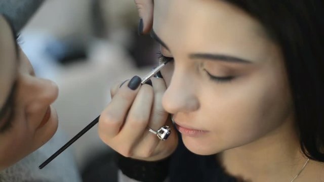 makeup artist makes models eye makeup close up