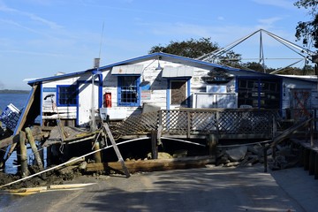 Fototapeta premium Bait shop on the river destroyed by hurricane Matthew hitting along the east coast of Florida, USA