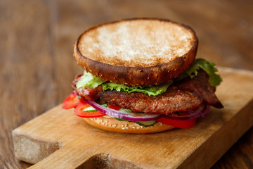 Classic american burger, fast food on wood background