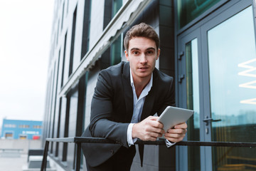Fototapeta premium Business man standing with laptop computer