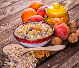 oatmeal in a sac, dried apricots, raisins, grapes, nuts on the b