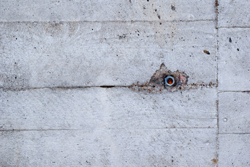Old concrete wall with bolt