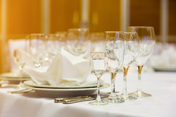 catering table set service with silverware, napkin and glass at restaurant before party