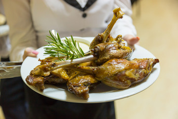 Waiter holding a plate of crow's feet