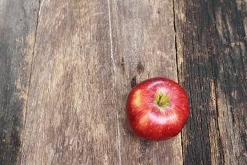 red apple on wooden background, top view with copy space.