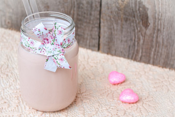 Pink Raspberry milkshake on Valentine's Day with hearts and whipped cream.