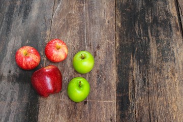 red and green apple on wooden background, top view 