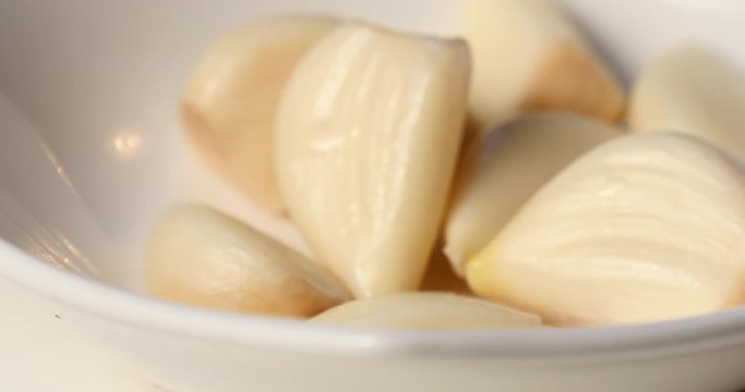 Close up of peeled garlic on a dish