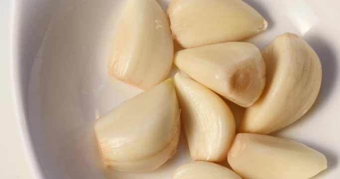 Close up of peeled garlic on a dish