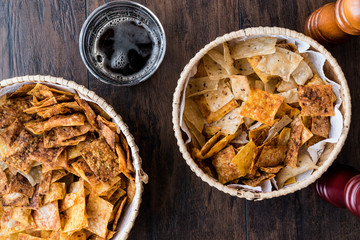 Homemade Crispy Chips / Snacks in a wicker bowl with beverage