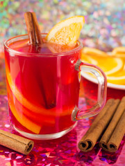 Transparent mug with citrus mulled wine, cinnamon and orange