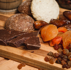 chocolate, dried apricots, and homemade cookies on a wooden board