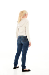 Full length portrait of a pretty girl wearing a casual white hoody and blue jeans. standing pose isolated against a white background.