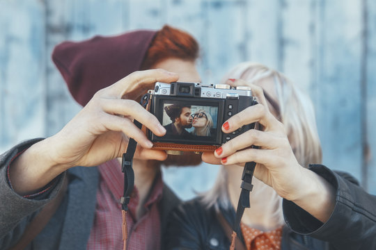 Young couple taking a selfie with vintage camera