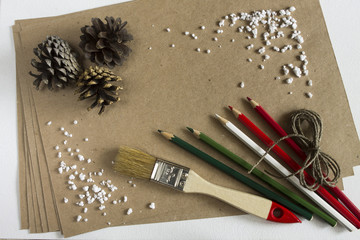 Cristmas frame with color pencils, paper and brush