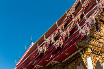 Fototapeta premium Temple roof vintage Thai style with against blue sky background