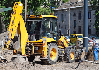 Excavator works at the road construction