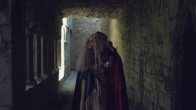 4k Medieval Shot of Game of Thrones Style Queen Walking in Castle with Candle