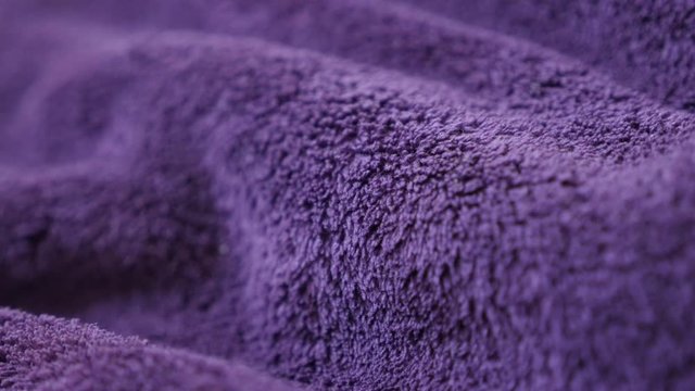 Violet polar blanket synthetic fibers and texture panning 4K 2160p 30fps UltraHD footage - High quality warming fleece purple polyester fabric material slow pan 3840X2160 UHD video 