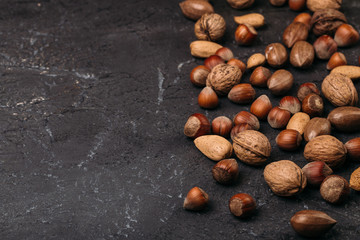 Background of mixed nuts - hazelnuts, walnuts, almonds - with copy space. 