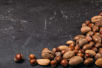Background of mixed nuts - hazelnuts, walnuts, almonds - with copy space. 