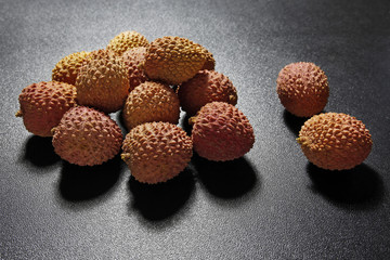 lychee fruits on black background