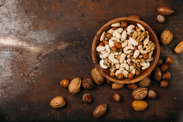 Background of mixed nuts - hazelnuts, walnuts, almonds - with copy space. 