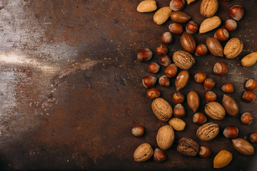 Background of mixed nuts - hazelnuts, walnuts, almonds - with copy space. 