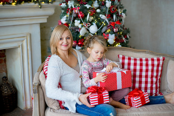 Obraz na płótnie Canvas girl and grandmother with Christmas gifts