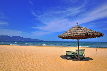 Chairs and umbrella on the sand beach