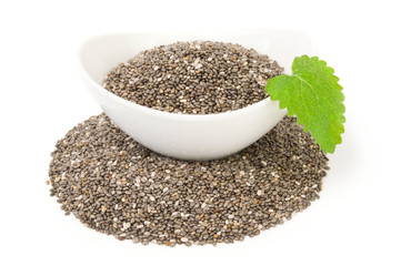 Nutritious chia seeds isolated over a white background