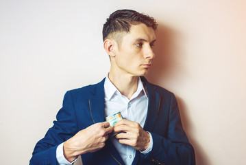 man businessman taking notes in pocket as a bribe