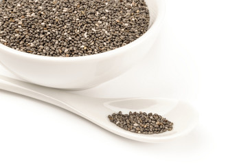 Organic dry chia seeds isolated over a white background