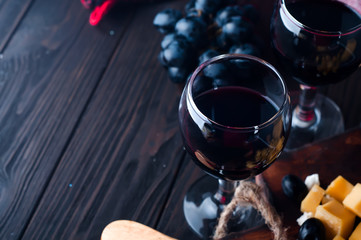 two glasses of red wine, grapes
