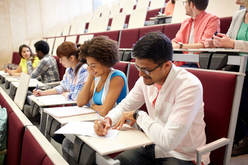 group of students with notebooks in lecture hall