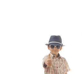 Caucasian kid with hat and sunglasses . Isolated on white background. Space for copy or other design.Thumbs up.Business concept