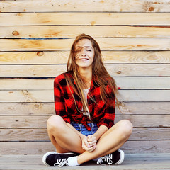 Portrait of beautiful young woman in stylish urban clothes