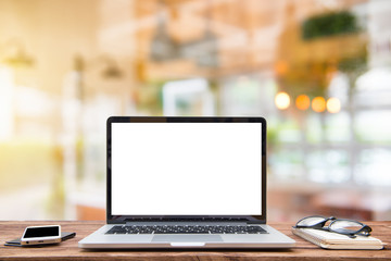 Laptop with blank screen on table