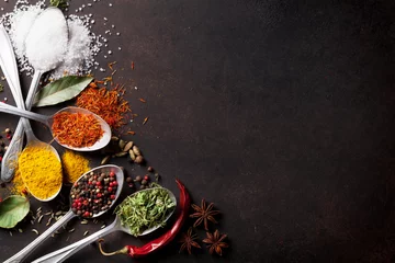 Zelfklevend Fotobehang Various spices spoons on stone table © karandaev