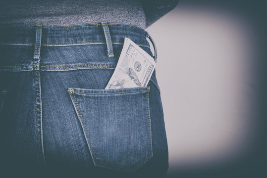 dollars sticking out of his pants pocket