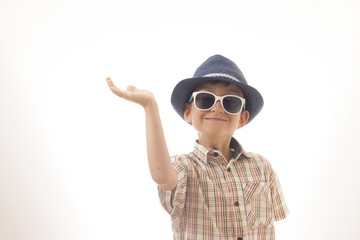 Caucasian kid with hat and sunglasses holding his hand up. Isolated on white background. Space for copy or other design.Business concept.