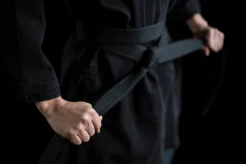 Keuken foto achterwand Confident karate player holding his belt © WavebreakmediaMicro