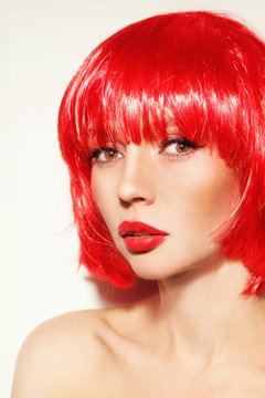 Portrait of young beautiful sexy red-haired girl with bob haircut and red lipstick