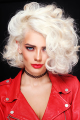 Portrait of young beautiful sexy stylish platinum blonde woman in red leather jacket