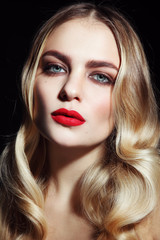 Fototapeta premium Portrait of young beautiful glamorous woman with red lipstick and blonde curly hair