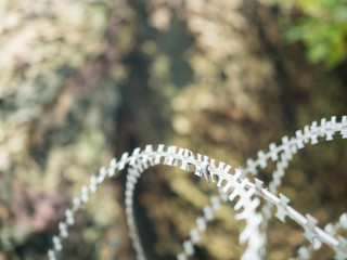 Barbed wire with battlefield background.