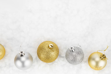 Gold and silver Christmas baubles isolated against white